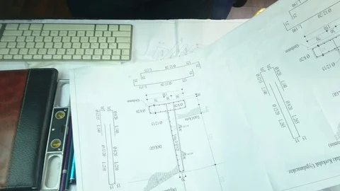 Female architect drawing on blueprint using rulers. Stock Footage 90099501