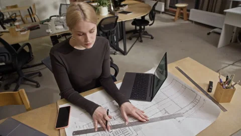Female Architect Drawing Floor Plan and Reviewing Digital 3D House Model Stock Footage 327849852