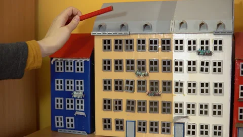 Female architect measures model house. Stock Footage 88324380