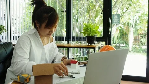 Female Architect Or Engineer use Vernier Caliper to measure the model house. Stock Footage 114699083