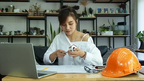 Female Architect Or Engineer use Vernier Caliper to measure the model house. Stock Footage 119119543