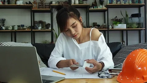 Female Architect Or Engineer use Vernier Caliper to measure the model house. Stock Footage 120772227