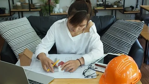 Female Architect Or Engineer use Vernier Caliper to measure the model house. Stock Footage 124404430