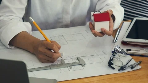 Female Architect Or Engineer use Vernier Caliper to measure the model house. Stock Footage 125947391