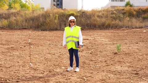 Female architect standing in a construction site Stock Footage 334578401