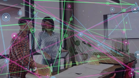 Female architect tapping tablet starting node map over plans while male pointing Vidéo 333648899