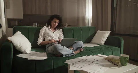 Female architect using laptop on sofa Stock Footage 207669391