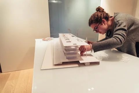 Female architect working on architecture model on table Stock Photos