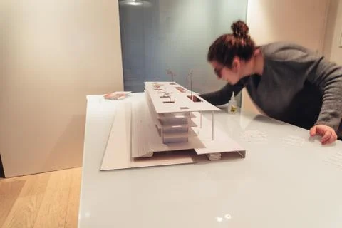 Female architect working on architecture model on table Stock Photos