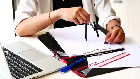 The female architects are using dividers and tools for idesign on the bluepri Stock Footage 79609782