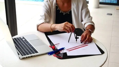 The female architects are using dividers and tools for idesign on the bluepri Видео 79609787