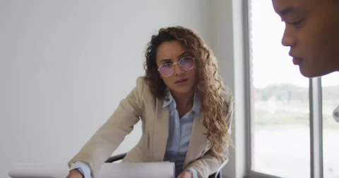 Female architects talking and checking architects plans in modern office Stock Footage 336056807