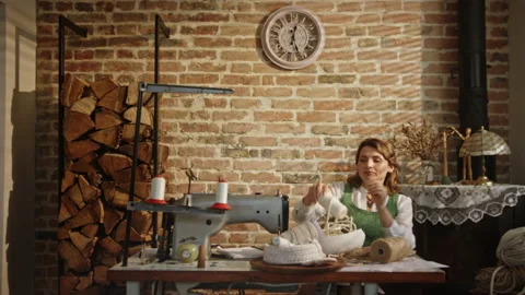 Female artisan preparing to work in workshop. Pan right view of adult woman Video stock 211808218