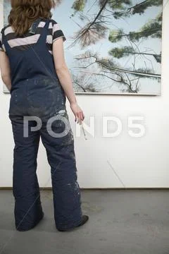 Female Artist With Paintbrush Looking At Painting Stock Photos