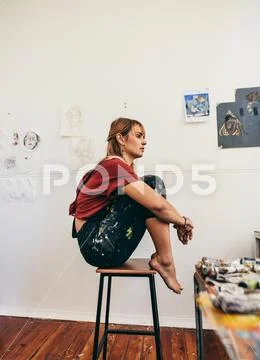 Female artist sitting in her workshop Stock Photos