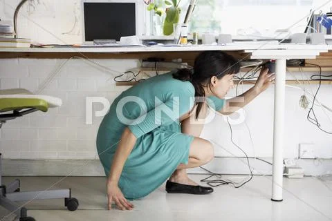 Female Artist Using Cell Phone At Desk Stock Photos