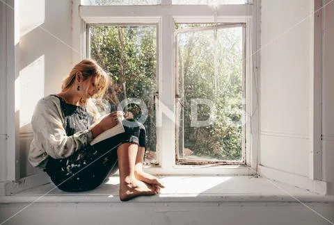 Female artist in workshop making a sketch in book Stock Photos