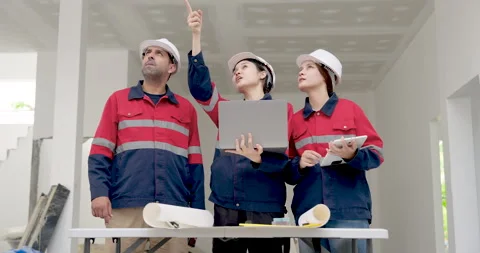 Female Asian engineer points upward during unfinished building inspection, Stock Footage 336537103