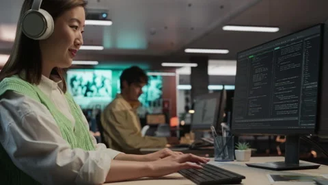 Female Asian Programmer Coding In Game Development Office Stock Footage 255795442