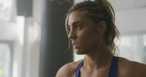 Female athlete breathing deeply while looking at the camera Stock Footage 99320519