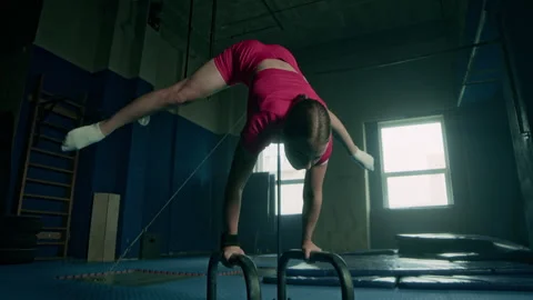 Female Athlete Demonstrating Acrobatic Elements on Parallel Bars Stock-Footage 282363104