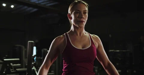 Female athlete does weight training with dumbbells Stock Footage 83185832
