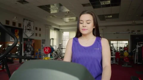 Female athlete doing exercise by running or walking on treadmill. Stock Footage 154894247