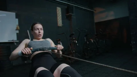 Female Athlete Doing Intense Upper Body Workout on Rowing Machine Video stock 282431036