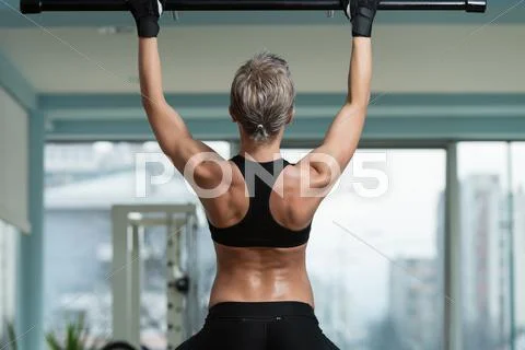 Female athlete doing pull ups Stock Photos