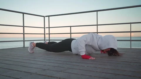 Female athlete doing before push ups exercises Stock Footage 233035105