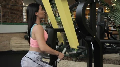 Female athlete doing row machine exercise in gym. Stock Footage 83406141