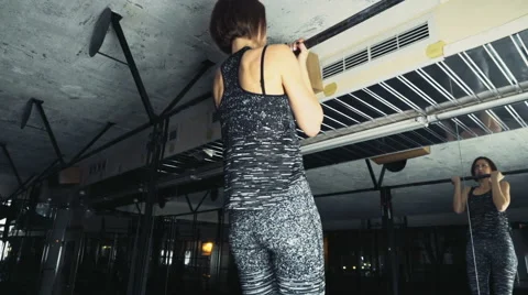 Female athlete doing standard pull-ups at the gym slow motion Video stock 61291948
