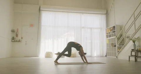 Female athlete doing yoga in a studio Stock Footage 99331237