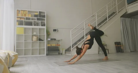 Female athlete doing yoga in a studio Stock Footage 99340108