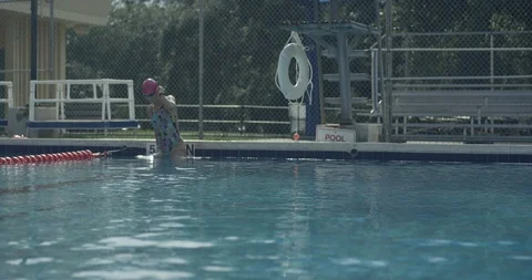 Female athlete getting into a pool Stock Footage 97058350