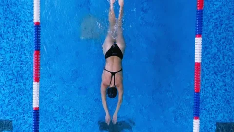 A female athlete practices in a pool doing professional strokes. Stock Footage