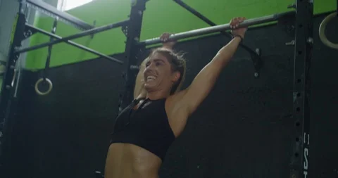 Female athlete training on a pull up bar Stock Footage 96960715