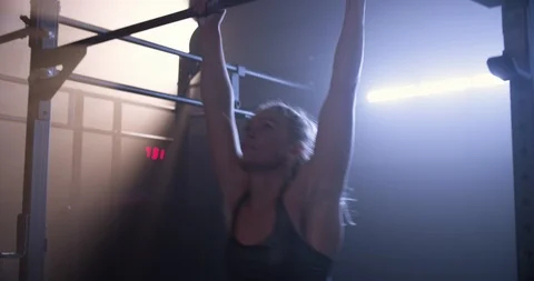 Female athlete training on a pull up bar Stock Footage 104004697