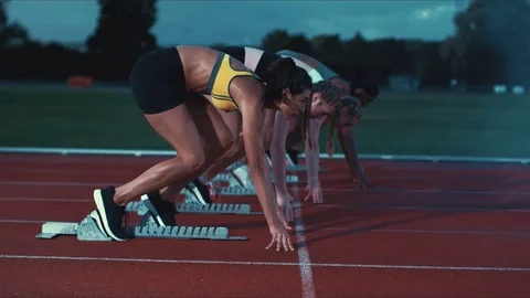 Track athlete landing in sand on long jump in super slow motion