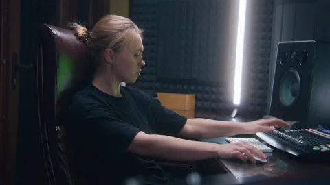Female audio engineer creates song with modern musical equipment Stock Footage 238989754