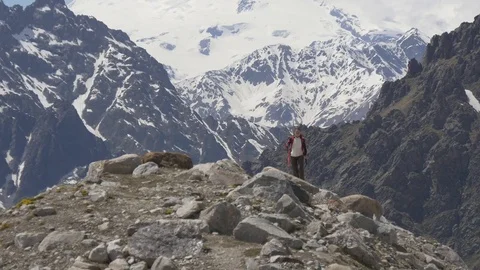 Female backpacker walking on mountain peak Stock Footage 76919402