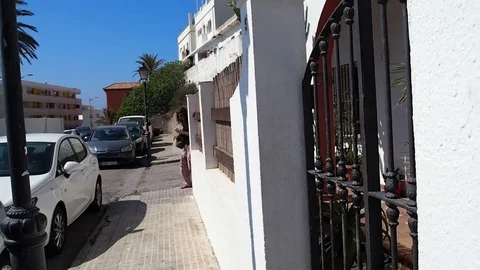 Female backpacker walks to a hostel Stock Footage 77618187
