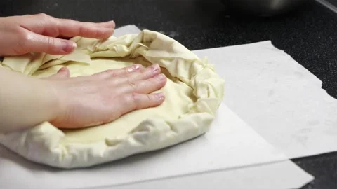 Female baker hands shaping fresh pastry dough for summer berry galette Stock Footage 336848386