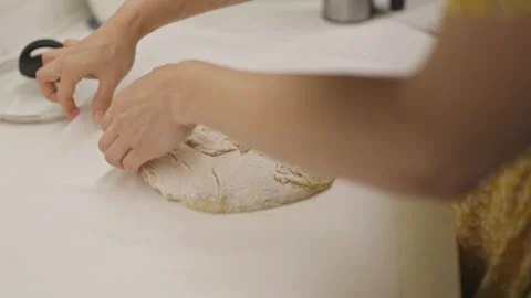 Female baker kneading and scoring sourdough bread dough Stock Footage 320110046