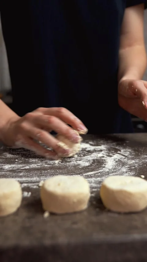 Female baker kneading dough for biscuits Stock Footage 337204378