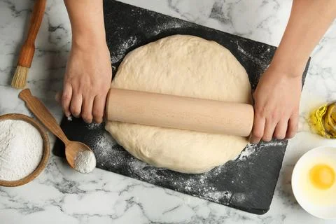 Female baker preparing bread dough at kitchen table, flat lay Stock Photos