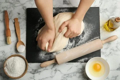Female baker preparing bread dough at kitchen table, flat lay Stock Photos
