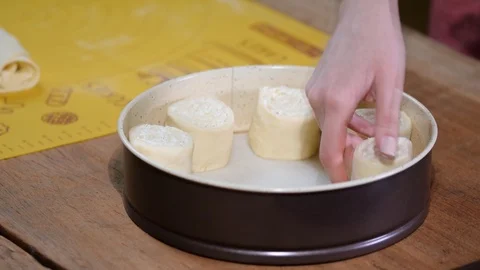 Female baker is putting buns to baking sheet, close up. Stock Footage 104714134