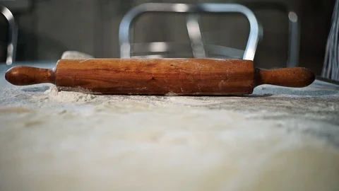 Female baker takes rolling pin for rolling dough Video stock 127636645