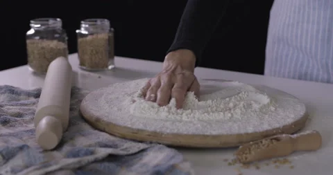 Female Baker touching flour on the table with hand. Stock Footage 138575999